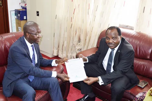 The DDG of WAHO (r) handing over the transfer letter to the Minister of Health and Sanitation (l) 